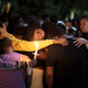 Mourners stand together as they hold a vigil in honor of slain 18-year-old Dwight “DJ” Grant on October 26, 2021 in Miramar, Florida. Miramar Police say that three teens planned and carried out the brutal murder of their Miramar High School classmate.